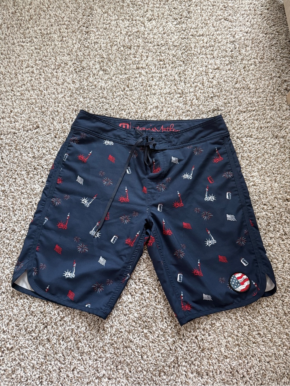 Travis Mathew Navy Swim Shorts with Red & White Liberty Icons